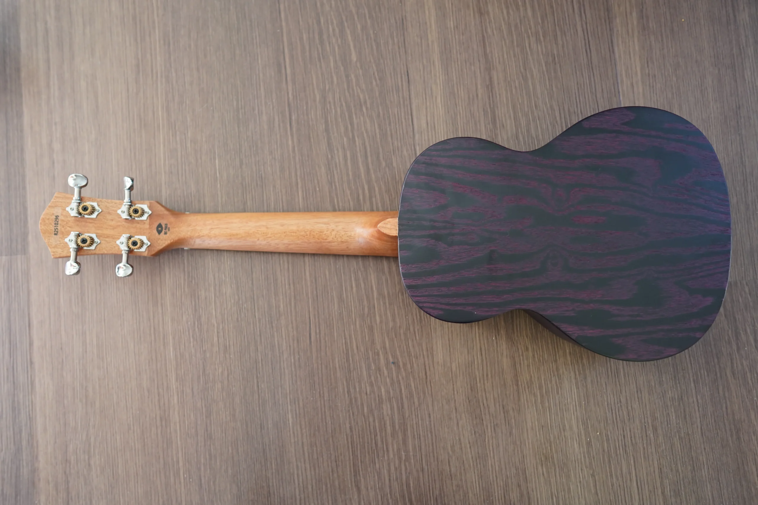 Full back view of the Flight DUC 400 Ash Purple ukulele highlighting the purple ash wood grain and natural mahogany neck.
