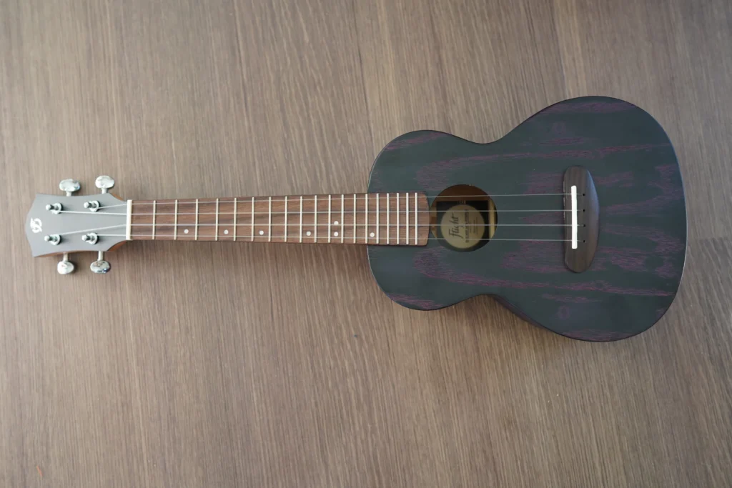 Full front view of the Flight DUC 400 Ash Purple concert ukulele featuring the ash wood top, rosewood fretboard, and purple grain finish.