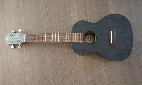 Full front view of the Flight DUC 400 Ash Purple concert ukulele featuring the ash wood top, rosewood fretboard, and purple grain finish.